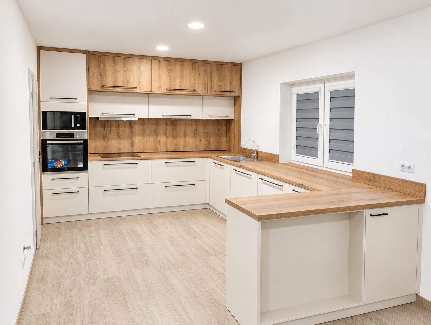 Moderní kuchyně na míru v dekoru dubu s krémovými dvířky, černými úchytkami a vestavnými spotřebiči